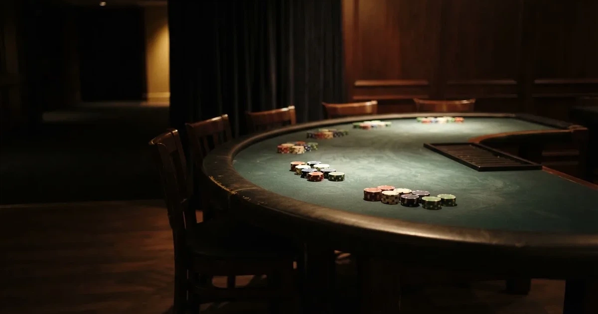 Ett halvmåneformat kortbord i en tyst sal, spelmarker framför varje plats och mjukt takljus — online spelautomater i sverige